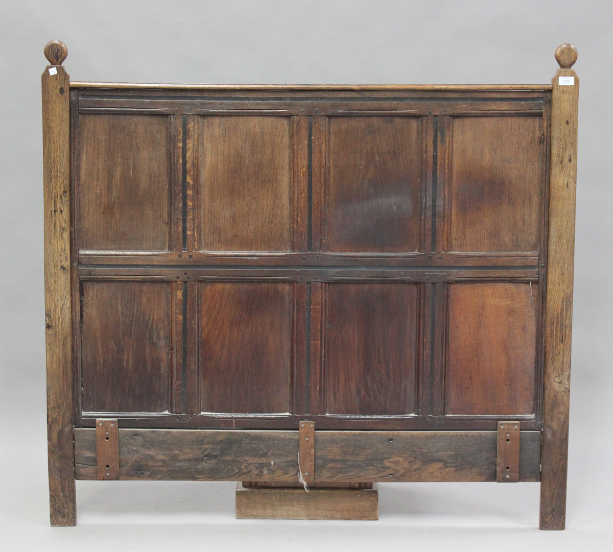 A 17th century and later oak panelled double headboard, height 130cm, width 139cm.Buyer’s Premium
