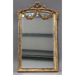 A modern French gilt composition pier mirror by Stephane Devoy, the arched top with ribbon and