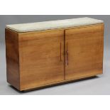 An Art Deco walnut side cabinet, the marble top above two doors enclosing drop-down drawers and