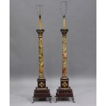 A pair of early/mid-20th century painted faux marble and gilt painted lamp standards of classical