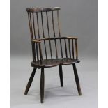 A 19th century primitive ash and elm Windsor armchair, the hoop and spindle back above a shaped