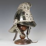 An early 20th century nickel plated Merryweather type fireman's helmet with dragon-decorated comb,