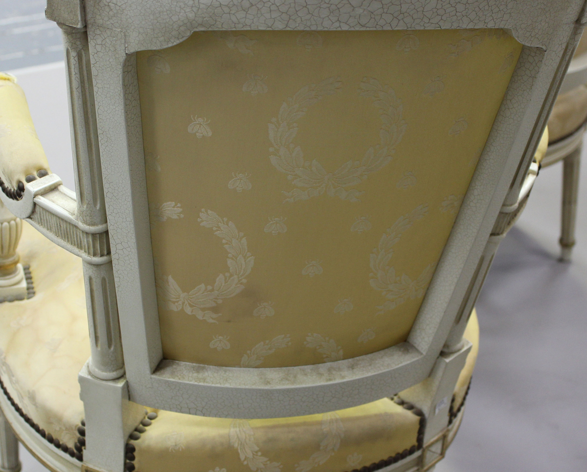A pair of 20th century Louis XVI style white painted and gilt fauteuil armchairs, upholstered in - Image 3 of 12