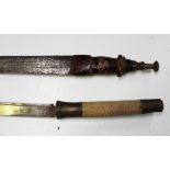 An early 20th century African Mandigo sword, blade length 76cm, with tooled and decorated leather