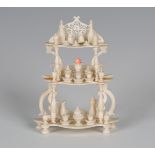A mid-19th century French ivory doll's house whatnot, the three tiers with applied turned vessels,