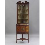 An Edwardian Neoclassical Revival mahogany bowfront corner display cabinet with painted