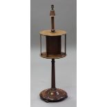 An early 20th century mahogany and anodized copper lamp standard with central bookstand section,