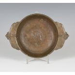 An early 20th century French brown patinated cast bronze twin-handled bowl, each handle cast as a