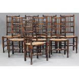 A set of eight 20th century stained ash and beech spindle back dining chairs with rush seats,