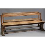 A pair of late 19th century oak pews with chamfered edges and Gothic arch supports, height 82cm,