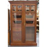 A pair of late Victorian mahogany gentleman's wardrobes, the moulded pediments above later glazed