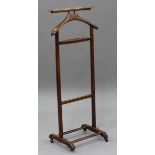 An early/mid-20th century mahogany gentleman's clothes stand, height 110cm, width 46cm.Buyer’s