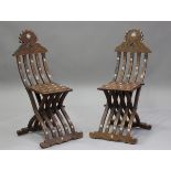 A pair of late 19th/early 20th century Middle Eastern walnut and bone inlaid folding chairs, the