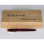 A Nakaya deep burgundy coloured fountain pen, the Nakata gold nib detailed '14K Japan', with a