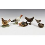 An early 20th century cold painted spelter model of a chicken, height 6cm, a moulded composition