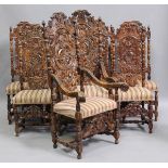 A set of eight impressive late 19th/early 20th century carved oak dining chairs with overall