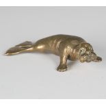 A 19th century cast bronze model of a sea lion, finely cast and inset with one green glass eye,