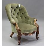 A mid-Victorian walnut tub back armchair, upholstered in buttoned green velour, on carved cabriole