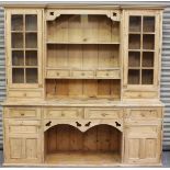 A late 20th century pine kitchen dresser, the shelf back with glazed cabinets and drawers, the