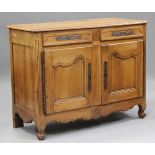 An 18th century French cherry side cabinet, the two drawers and two cupboard doors with applied