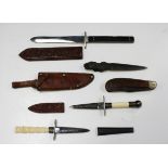 A small collection of various small-bladed knives, including an American 'Self Defender' style