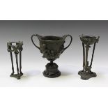 A 19th century dark green patinated bronze twin-handled urn, the body cast in high relief with