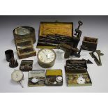 A group of watchmaker's tools and accessories, including a bench lathe, staking tools, drill bits,