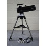 A Sky-Watcher Newtonian telescope, detailed 'D-114mm f=500mm', with motorized mount and tripod.