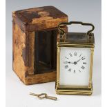 A 20th century lacquered brass carriage timepiece with eight day movement, the enamelled dial with