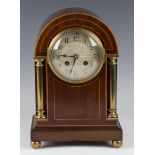 An Edwardian mahogany and brass mounted mantel clock with eight day movement striking on a gong, the