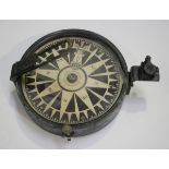 A black enamelled brass cased compass, the printed circular dial inscribed 'Henry Barrow & Co 26