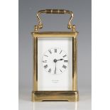 An early 20th century lacquered brass cased carriage clock with eight day movement striking hours