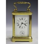 An early 20th century French lacquered brass diminutive carriage alarm clock with eight day movement