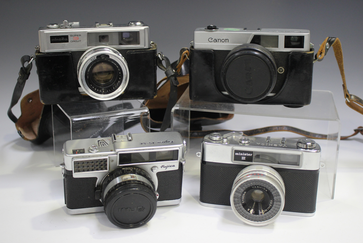 A collection of assorted cameras, including a Minolta Super 3 Circuit, a Canon Canonet, a Yashica