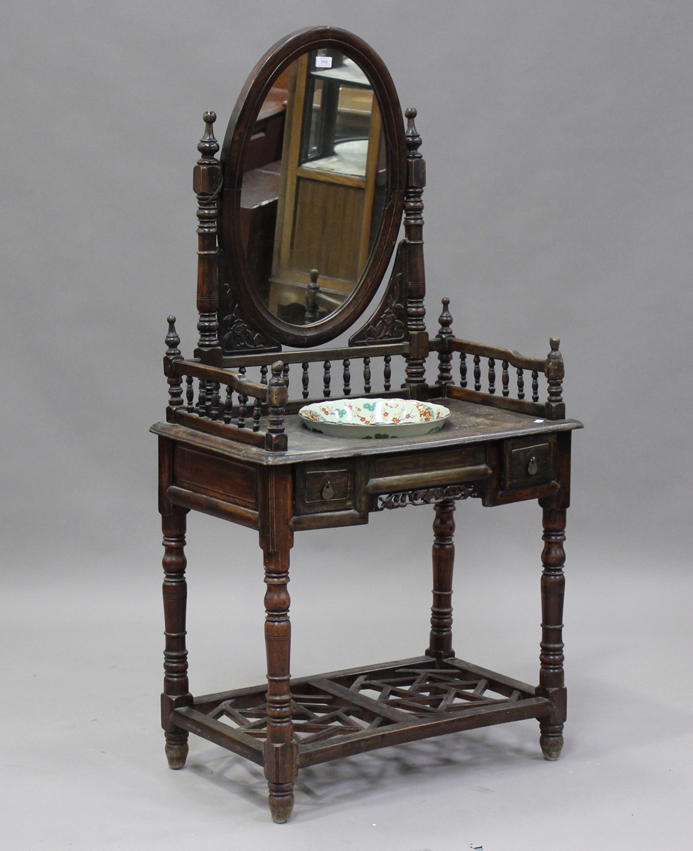 A 20th century Chinese stained softwood washstand with oval swing frame mirror, height 158cm,
