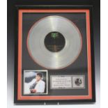 A group of framed music memorabilia, including a limited edition replica disc of Michael Jackson's