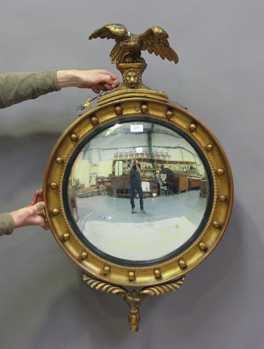 A 20th century Regency style gilt painted circular convex wall mirror with eagle surmount, height