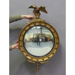 A 20th century Regency style gilt painted circular convex wall mirror with eagle surmount, height
