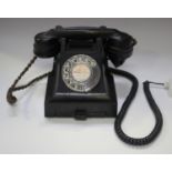 A mid-20th century 300 series black telephone, the underside detailed '332 CB', the handset detailed
