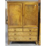 A George IV mahogany linen press, fitted with sliding trays enclosed by two doors above two short