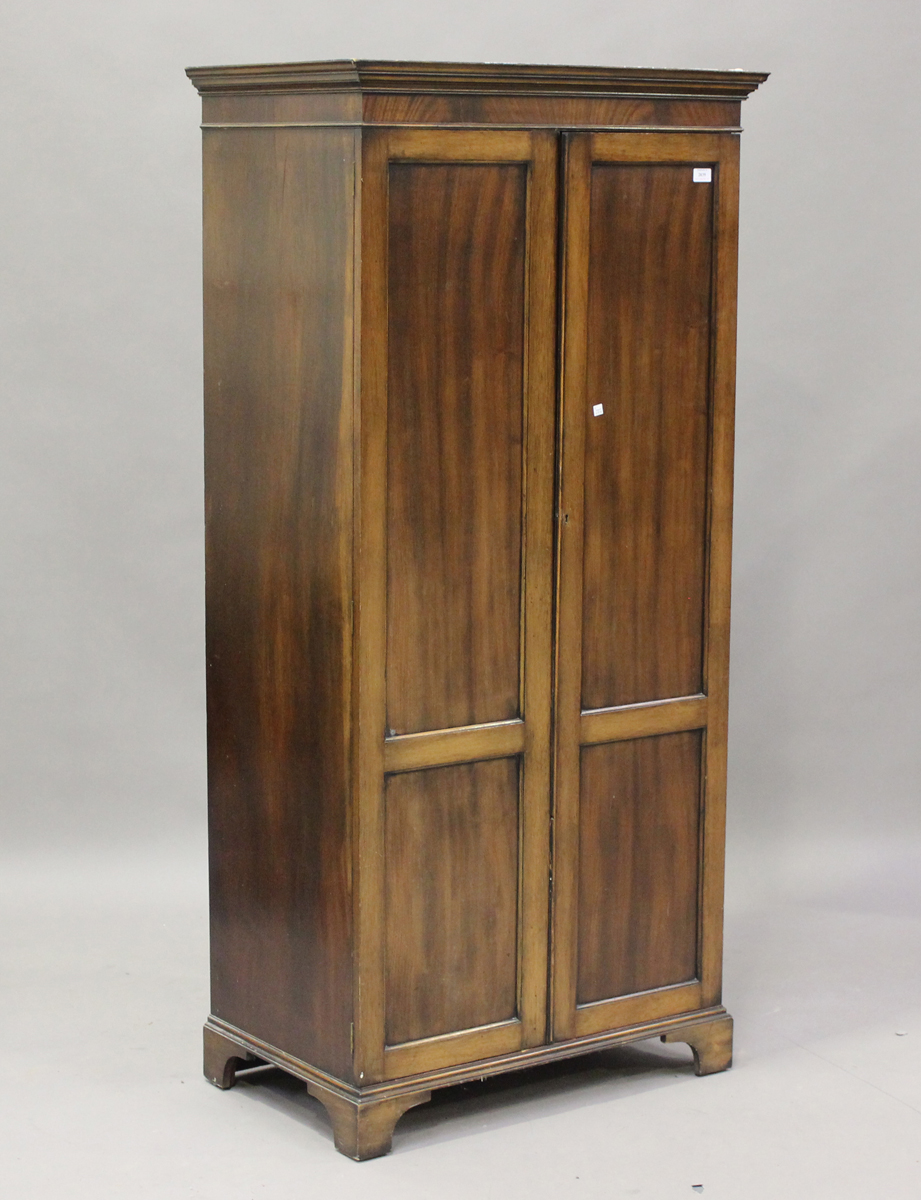 A mid-20th century mahogany two-door wardrobe, on bracket feet, height 175cm, width 83cm, depth