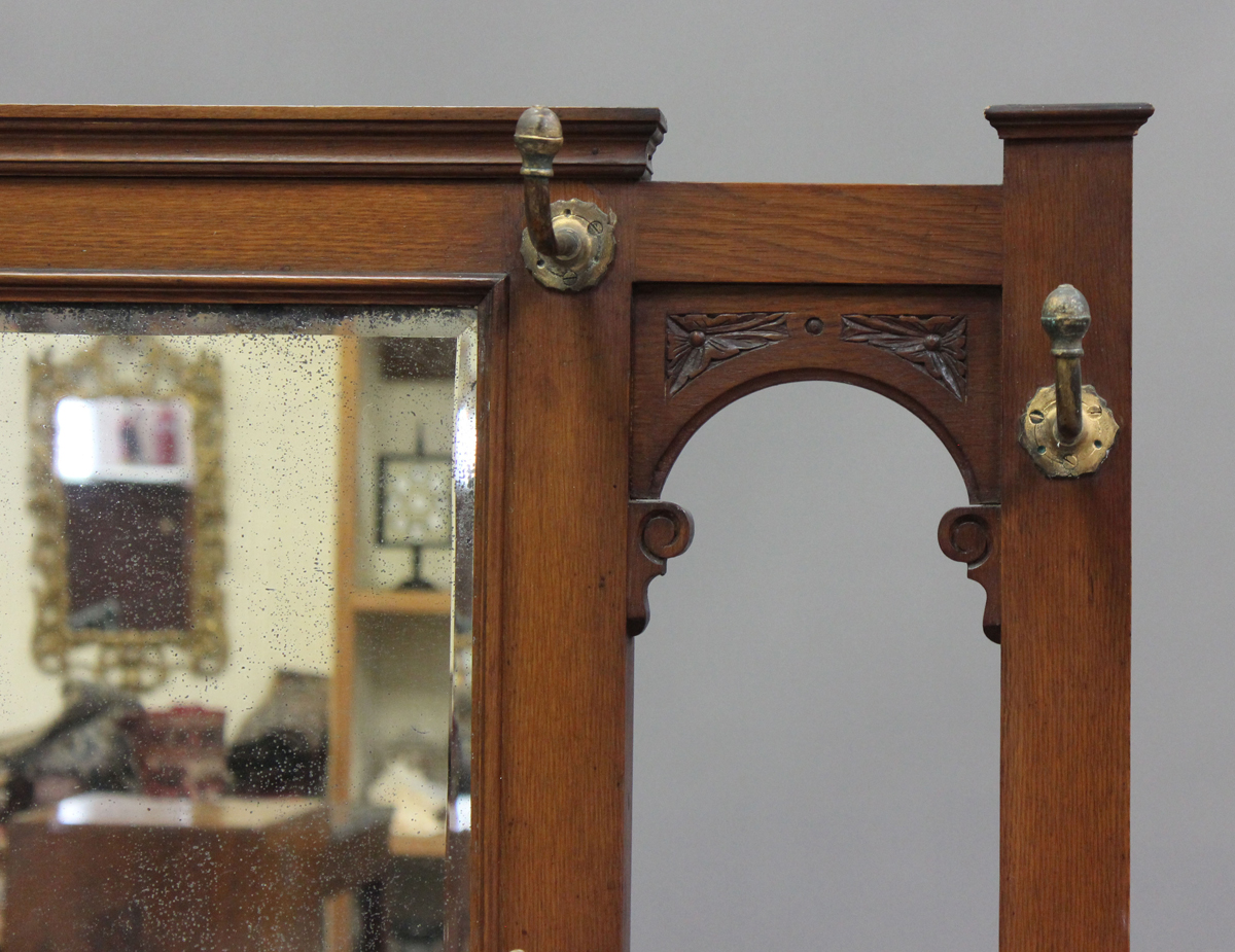 A late Victorian oak hallstand with carved foliate decoration, fitted with a drawer, on turned - Image 6 of 6