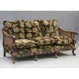 An early 20th century Queen Anne style walnut framed three-piece bergère suite, comprising a settee,