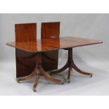 A 20th century George III style mahogany twin pedestal dining table with two extra leaves, height