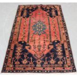 A Shirvan rug, South-east Caucasus, mid-20th century, the pink field with a winged medallion hung