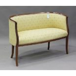 An Edwardian satinwood framed tub back salon settee, upholstered in patterned yellow damask,