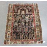 A Caucasian prayer rug, late 19th/early 20th century, the charcoal mihrab filled with boteh and