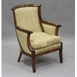 An early 19th century mahogany showframe library armchair, possibly Russian, covered in a checked