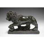 A 20th century carved green serpentine marble model of a Medici lion, height 24.5cm, length 34cm.