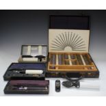 A group of ophthalmic equipment, including two cased set of lenses, ophthalmoscopes and a